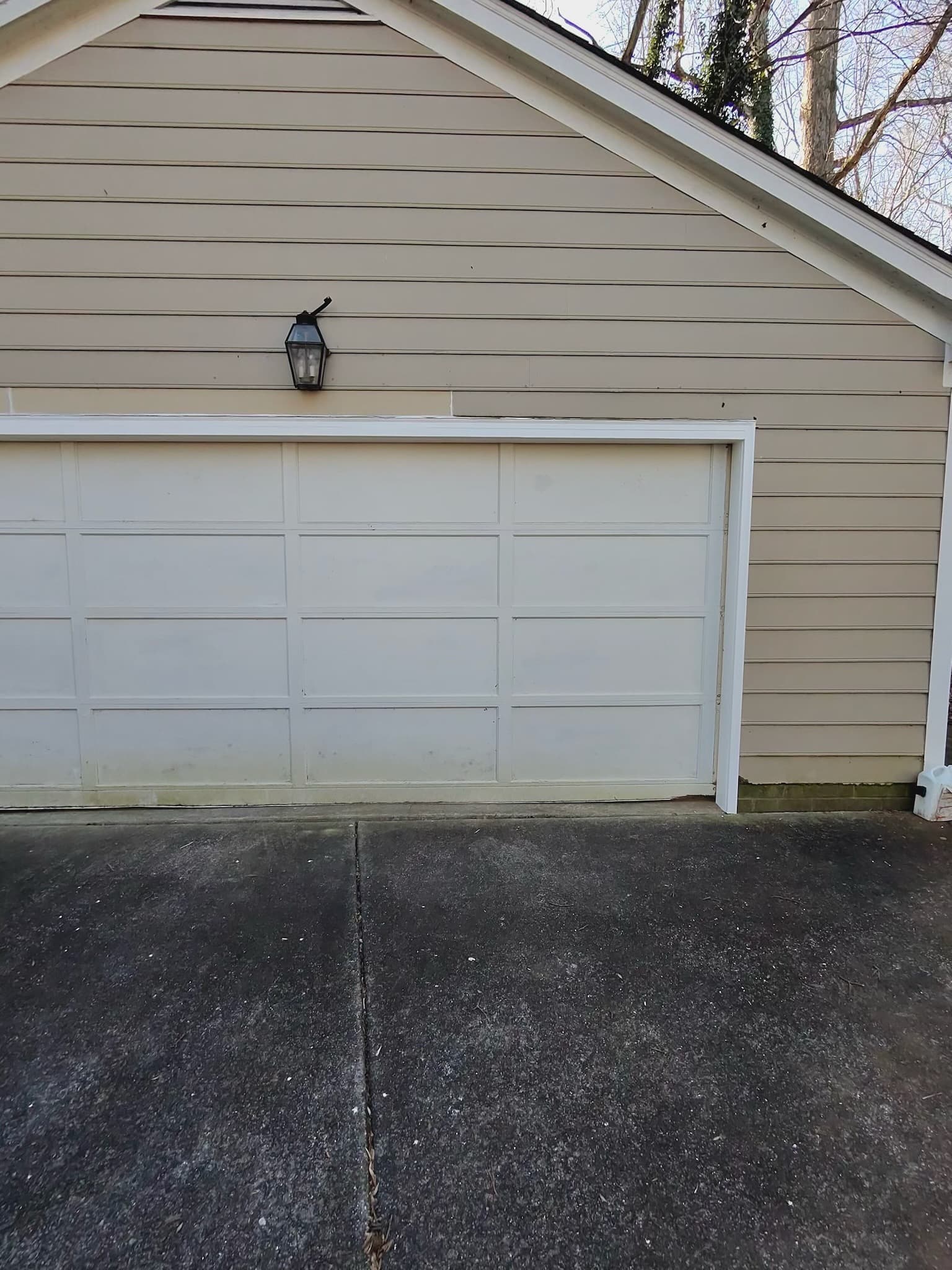 Damaged garage door before repair in Piedmont Triad