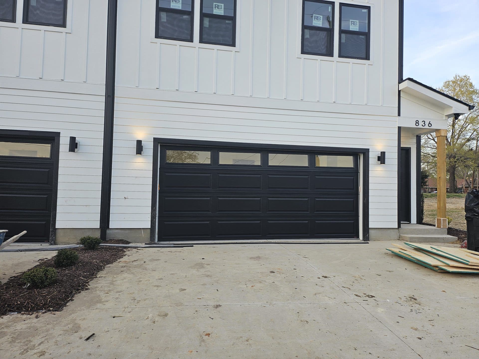 Black raised-panel door on new construction duplex in Burlington NC