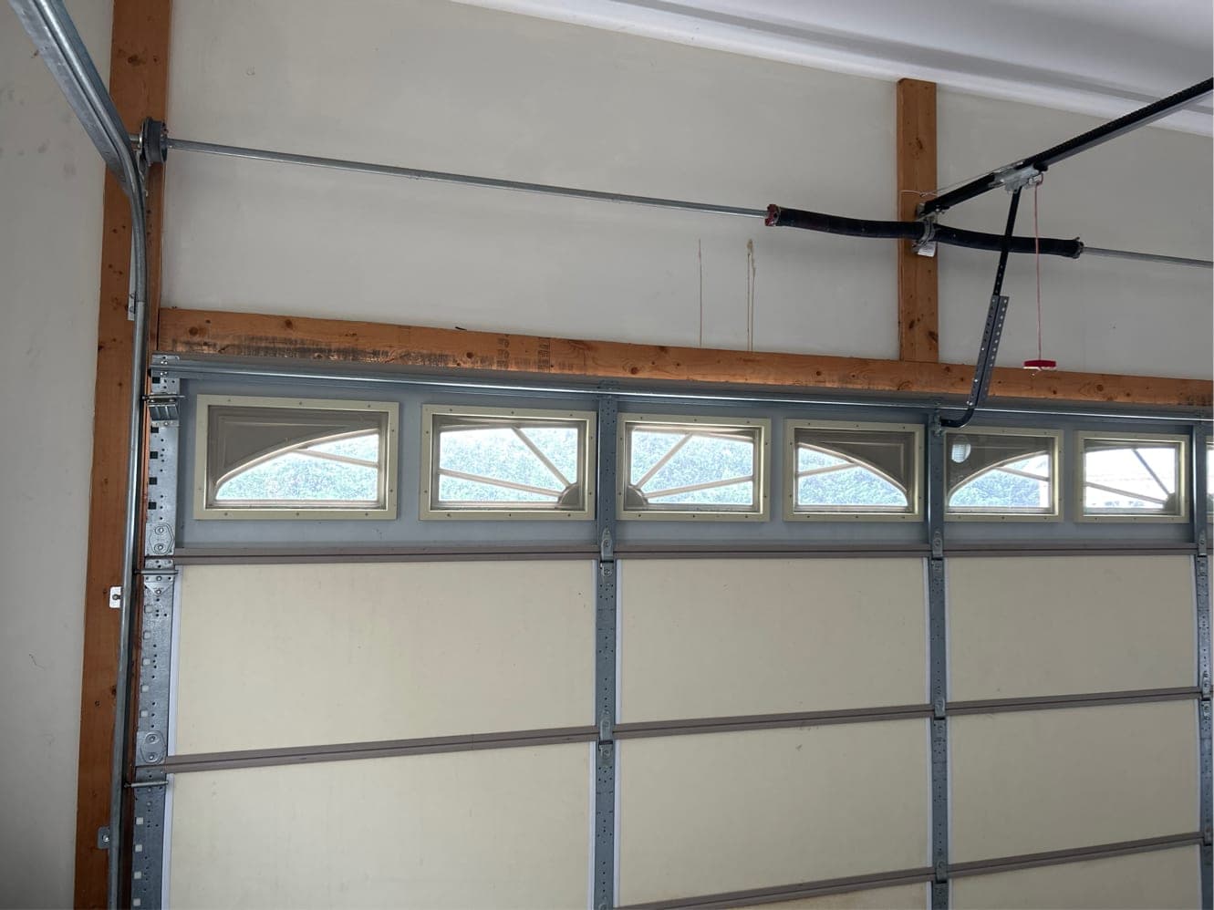Premium garage door interior with arch-top window inserts torsion spring and strut system NC