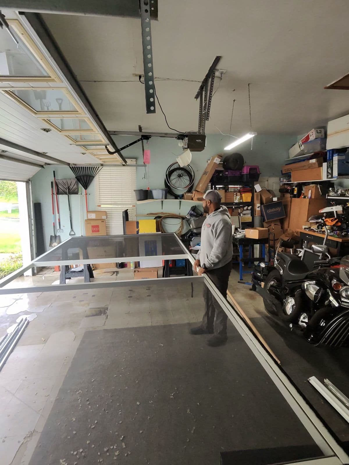 TNGD technician assembling garage screen panel