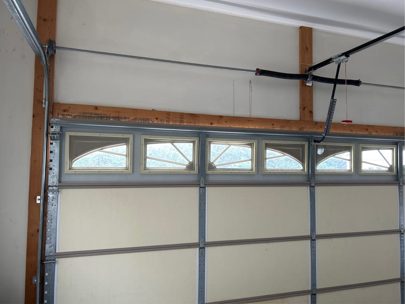 Premium garage door interior with arch-top window inserts torsion spring and strut system NC
